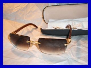 is an authentic par of Cartier Sunglasses. Burgandy tint, wood rims